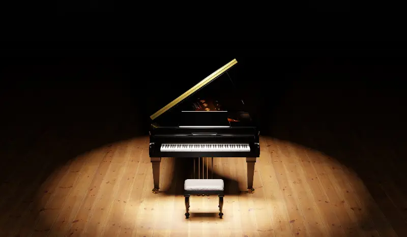Piano à queue noir seul sur une scène sombre, sous un projecteur